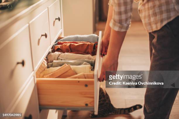 chest of drawers with hand clothes - chest of drawers stock pictures, royalty-free photos & images