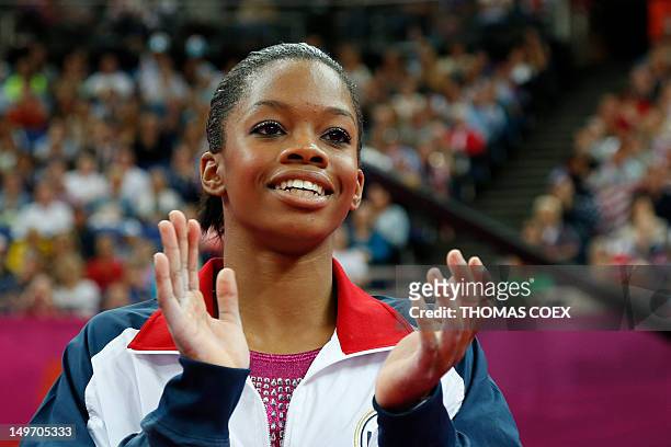 Gymnast Gabrielle Douglas celebrates after she won the artistic gymnastics women's individual all-around final at the 02 North Greenwich Arena in...