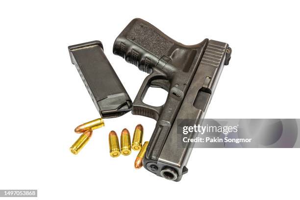automatic pistol and bullets is isolated on a white background. clipping path - revolver-with-silencer stock-fotos und bilder