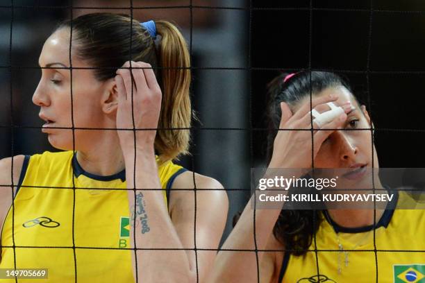 Brazil's Thaisa Menezes and Jaqueline Carvalho react during the Women's preliminary pool B volleyball match between Brazil and South Korea in the...