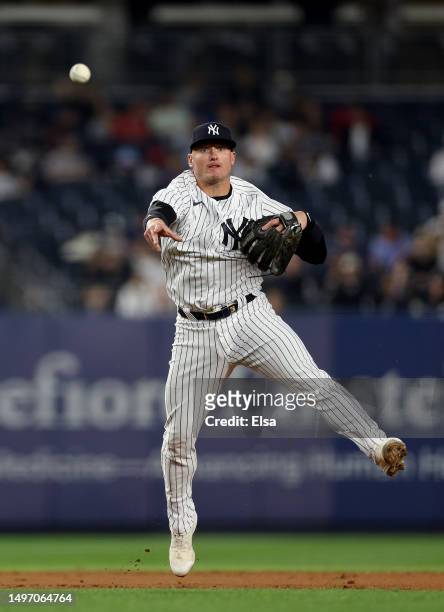 Josh Donaldson of the New York Yankees fields a hit by Yoan Moncada of the Chicago White Sox and sends it to first for the out in the ninth inning...