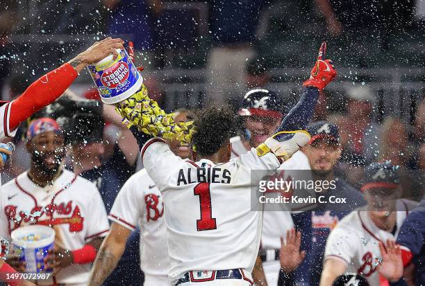 Ozzie Albies of the Atlanta Braves reacts after hitting a three-run walk-off homer in the 10th inning against the New York Mets at Truist Park on...