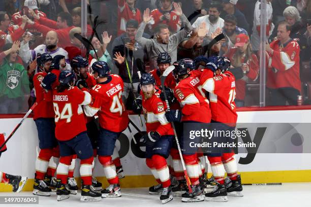 Carter Verhaeghe of the Florida Panthers is congratulated by his teammates after scoring the game-winning goal against the Vegas Golden Knights...