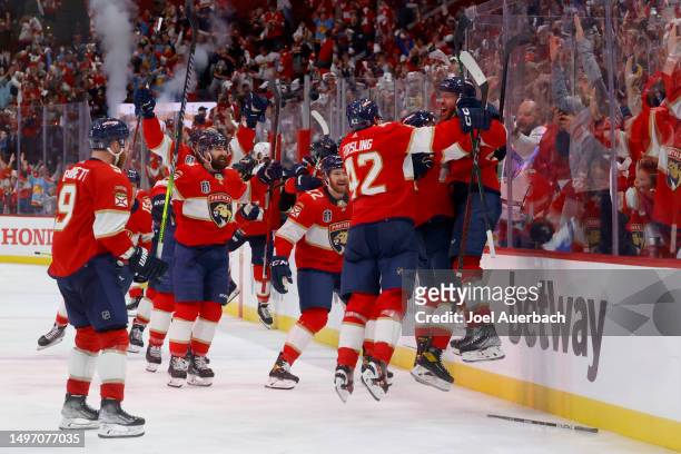 Carter Verhaeghe of the Florida Panthers is congratulated by his teammates after scoring the game-winning goal against the Vegas Golden Knights...