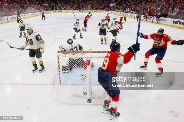 Matthew Tkachuk and Aaron Ekblad of the Florida Panthers celebrate the game-winning goal by teammate Carter Verhaeghe past Adin Hill during the first...