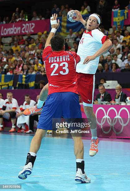 Mikkel Hansen of Denmark shoots over Nenad Vuckovic of Serbia in the Men's Preliminaries Group B match between Serbia and Denmark on Day 6 of the...