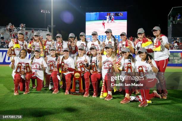 The Oklahoma Sooners pose for photos after their 3-1 victory against the Florida State Seminoles to win the Championship Series during Game Two of...