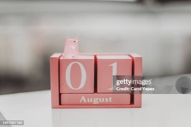 one of august calendar, on white table - august complex stock pictures, royalty-free photos & images