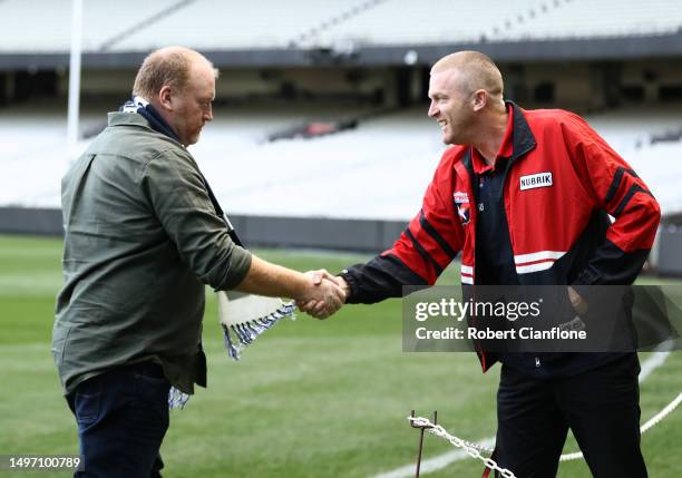 Former Carlton player Lance Whitnall and former Essendon player Dustin Fletcher greet each other during a Carlton Blues & Essendon Bombers Media...