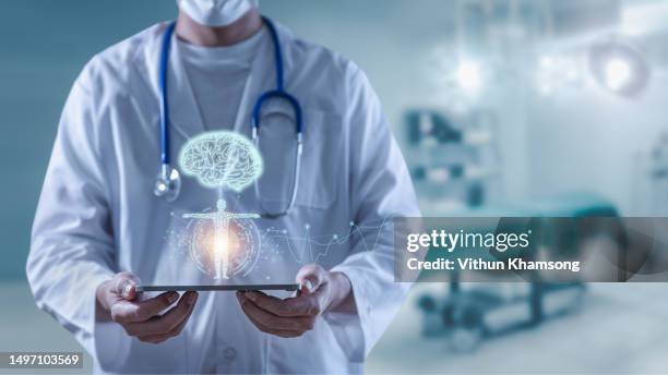 doctor holding tablet showing brain human and body anatomy futuristic technology - drugs stock pictures, royalty-free photos & images