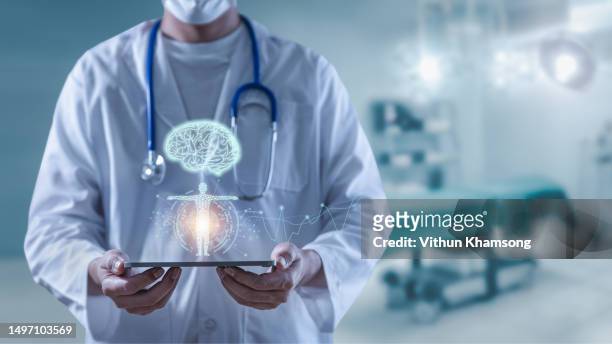 doctor holding tablet showing brain human and body anatomy futuristic technology - saúde e cuidados de saúde imagens e fotografias de stock