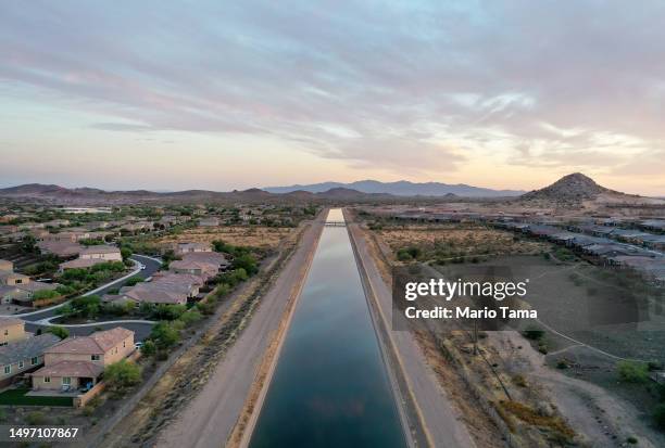 In an aerial view, the Central Arizona Project canal runs past homes in the Phoenix suburbs on June 8, 2023 in Peoria, Arizona. The project carries...