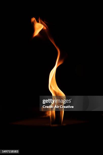 close-up of flame on black background - gas flame stock pictures, royalty-free photos & images