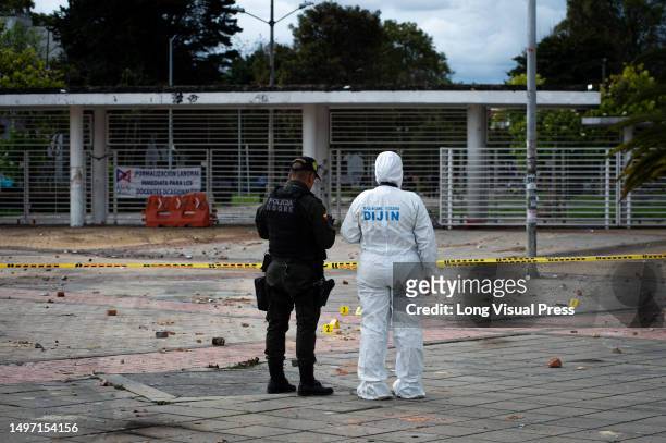 Colombia's forensic police and Anti-explosive police officers recover evidence after clashes between demonstrators and Colombia's Riot Police ended...