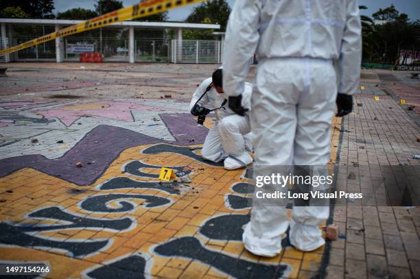 Colombia's forensic police and Anti-explosive police officers recover evidence after clashes between demonstrators and Colombia's Riot Police ended...