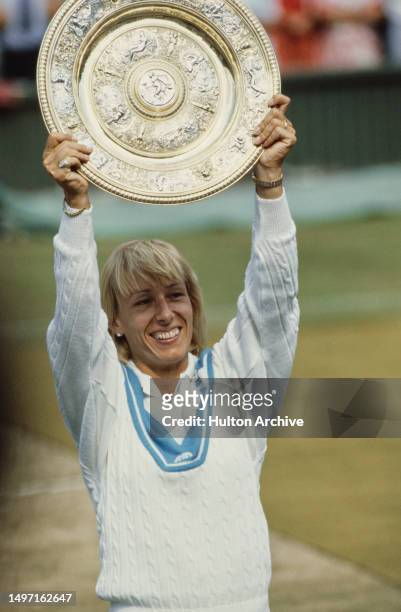 American tennis player Martina Navratilova holds the winner's trophy after the Final of he Women's Singles tournament at Wimbledon, All England Lawn...