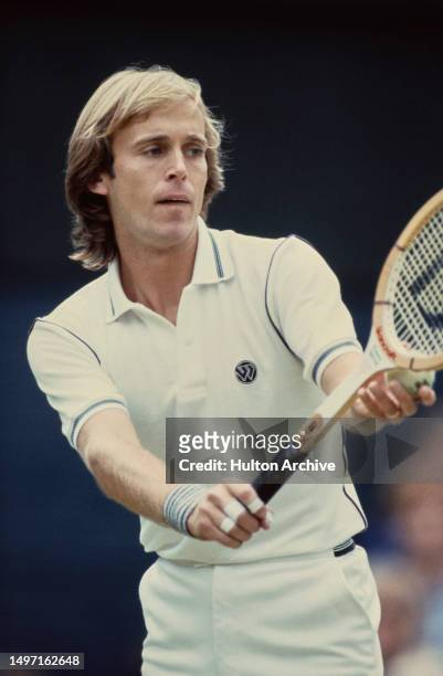 British tennis player John Lloyd readies to serve at Wimbledon, All England Lawn Tennis Club, London, 1981.