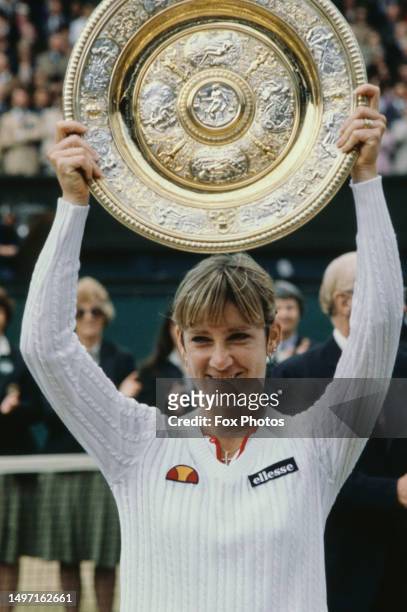 American tennis player Chris Evert Lloyd holds the winner's trophy after the Final of the Women's Singles tournament at Wimbledon, All England Lawn...