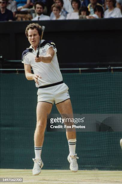 American tennis player John McEnroe plays a forehand during the Wimbledon Championships, All England Lawn Tennis Club, London, 1984.