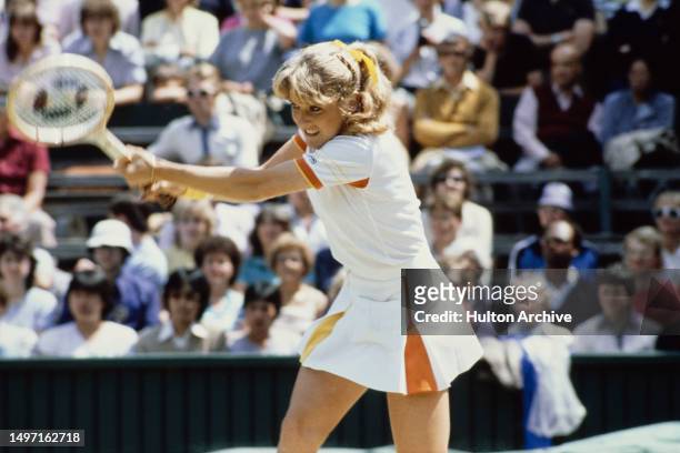 American tennis player Tracey Austin plays a backhand during the Quarter Final of the Women's Singles tournament at Wimbledon, All England Lawn...