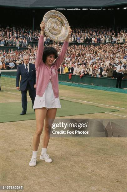 British tennis player Virginia Wade holds the Championship trophy after winning the Final of the Women's Singles tournament at Wimbledon, All England...