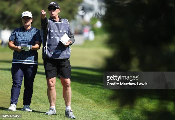 Lydia Hall of Wales talks with her caddie and former football referee, Mike Dean during Day Two of the Volvo Car Scandinavian Mixed at Ullna Golf &...