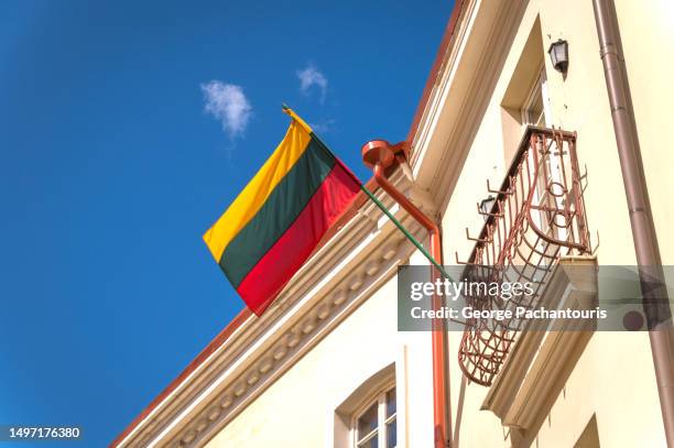 lithuania flag on a building - vilnius street stock pictures, royalty-free photos & images