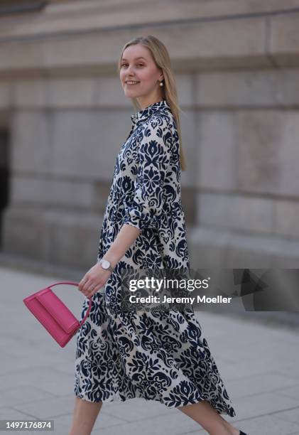 Lil Paulin seen wearing a darkblue and white flower printed long dress, pink mini handbag, Emporio Armani brown big shades, Daniel Wellington silver...