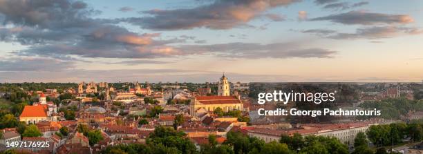 panorama of the old town of vilnius, lithuania at sunset - vilnius street stock pictures, royalty-free photos & images