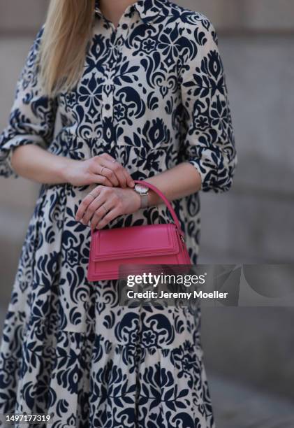 Lil Paulin seen wearing a darkblue and white flower printed long dress, pink mini handbag, Emporio Armani brown big shades, Daniel Wellington silver...