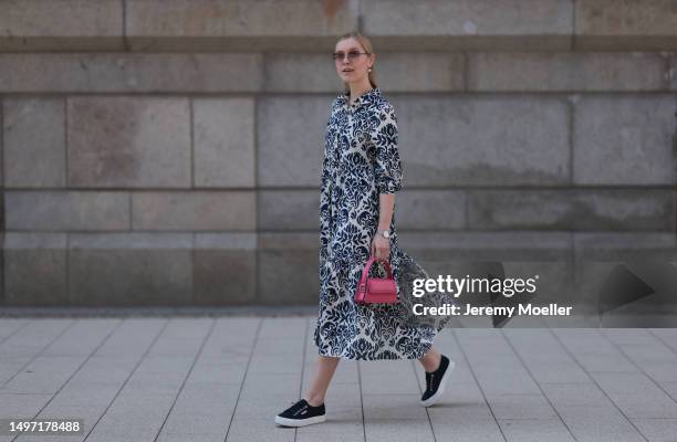 Lil Paulin seen wearing a darkblue and white flower printed long dress, pink mini handbag, Emporio Armani brown big shades, Daniel Wellington silver...