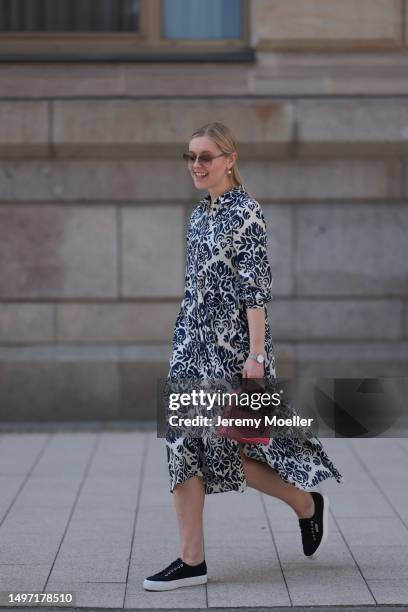 Lil Paulin seen wearing a darkblue and white flower printed long dress, pink mini handbag, Emporio Armani brown big shades, Daniel Wellington silver...