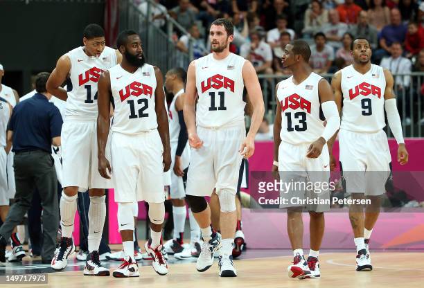 Anthony Davis of United States and teammates James Harden, Kevin Love, Chris Paul and Andre Iguodala walk onto the court during the second half...