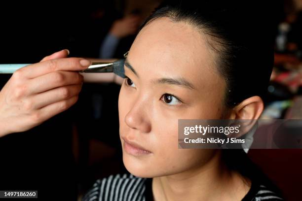 Model has their makeup done backstage at the Daniel w. Fletcher AW23 Collection at Royal Academy of Arts on June 09, 2023 in London, England.