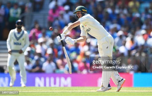 Marnus Labuschagne of Australia drops their bat after being struck by the ball off the bowl of Mohammed Siraj of India during day three of the ICC...