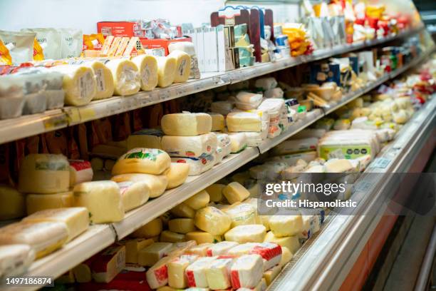 delicious variety of cheese in the dairy aisle refrigerated section of the supermarket - dairy aisle stock pictures, royalty-free photos & images