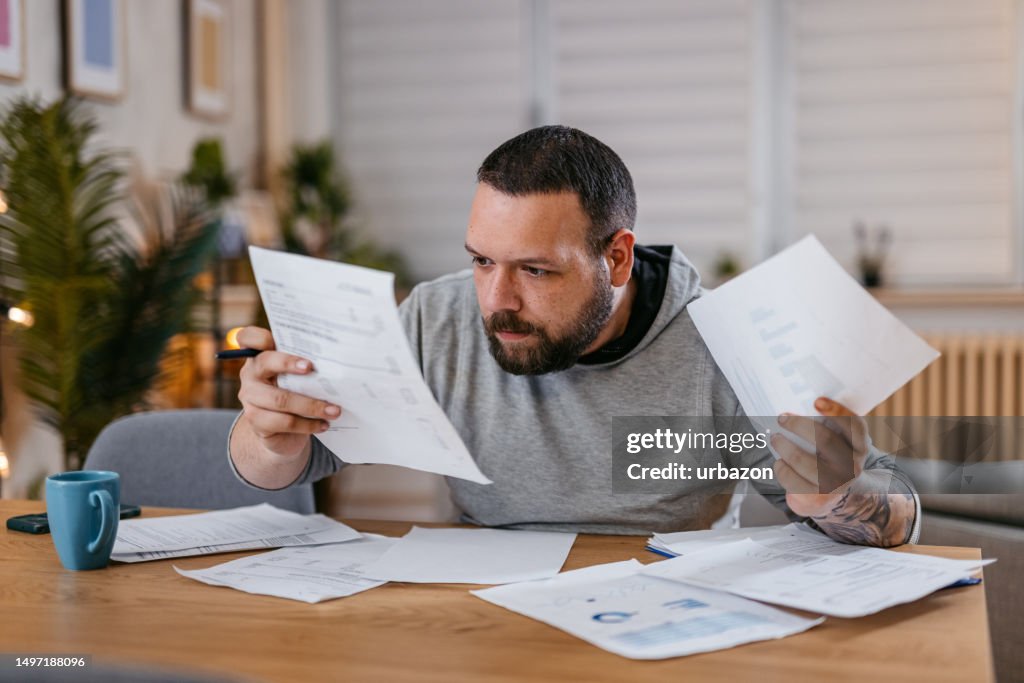 Man Checking Personal Finances at Home