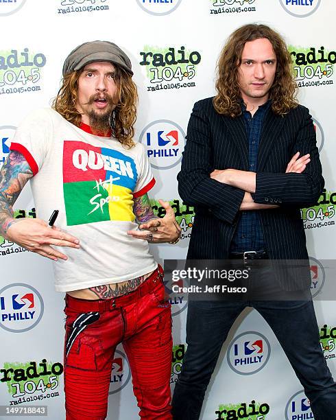 Justin Hawkins and Dan Hawkins of The Darkness pose at the Radio 104.5 iHeart Performance Theater on August 2, 2012 in Bala Cynwyd, Pennsylvania.