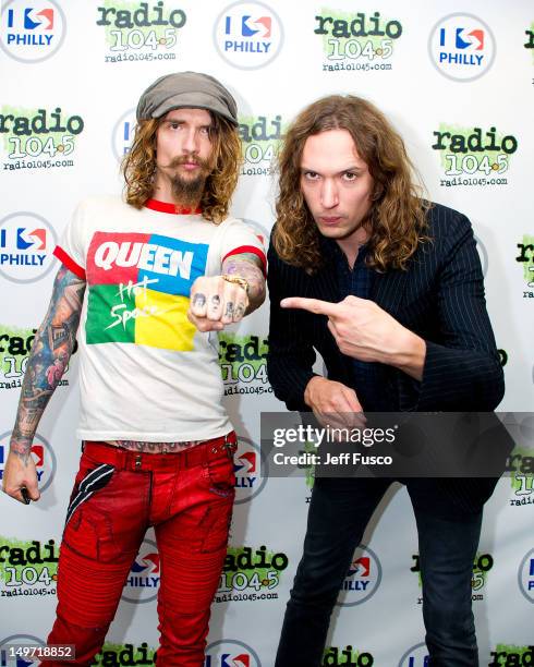 Justin Hawkins and Dan Hawkins of The Darkness pose at the Radio 104.5 iHeart Performance Theater on August 2, 2012 in Bala Cynwyd, Pennsylvania.