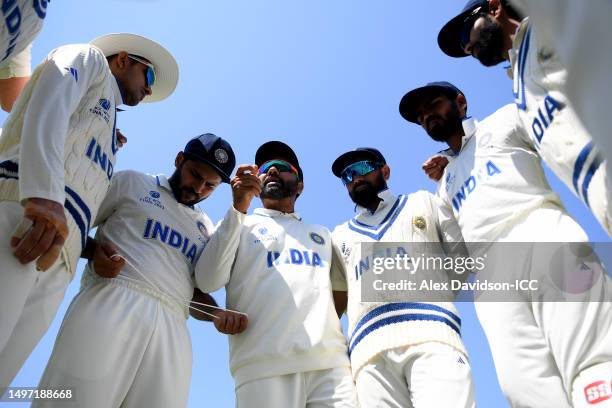 Rohit Sharma of India speaks with teammates as they huddle before fielding during day three of the ICC World Test Championship Final between...