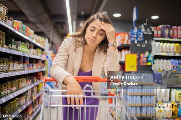 young woman in a supermarket - dolours price stock pictures, royalty-free photos & images