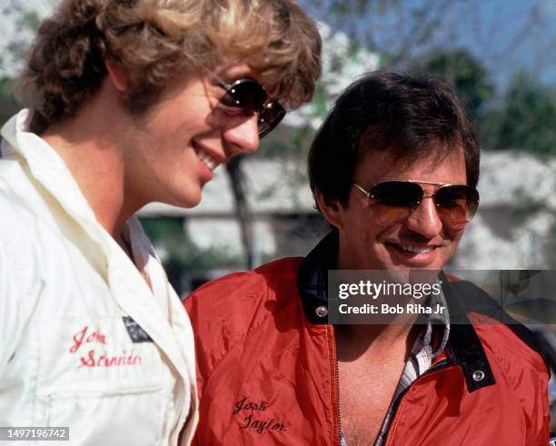 Actors Josh Taylor and John Schneider talk racing strategy prior to racing in celebrity race, March 14, 1981 in Long Beach, California.