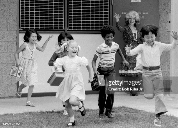 Elementary school students : Valarie Manley, Jacqueline Uribe, Katherine Martin, Brian Bishop and Abraham Wong jump for joy on the last day of school...