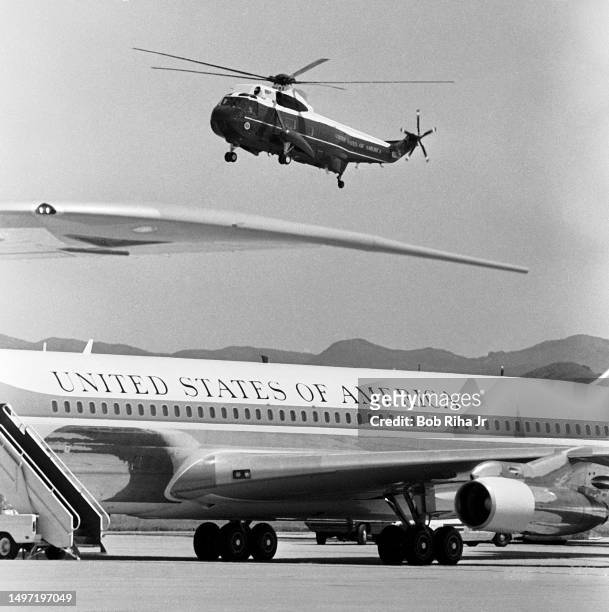 Marine One helicopter carrying U.S. President Ronald Reagan flies behind Tail number 26000 of Air Force One for landing at Point Mugu Naval Air...