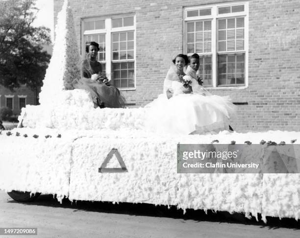 Members of the Delta Sigma Theta sorority riding on a float during Claflin University's homecoming event in the 1980s.
