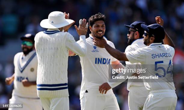 Umesh Yadav of India celebrates with teammates after taking the wicket of Usman Khawaja of Australia during day three of the ICC World Test...