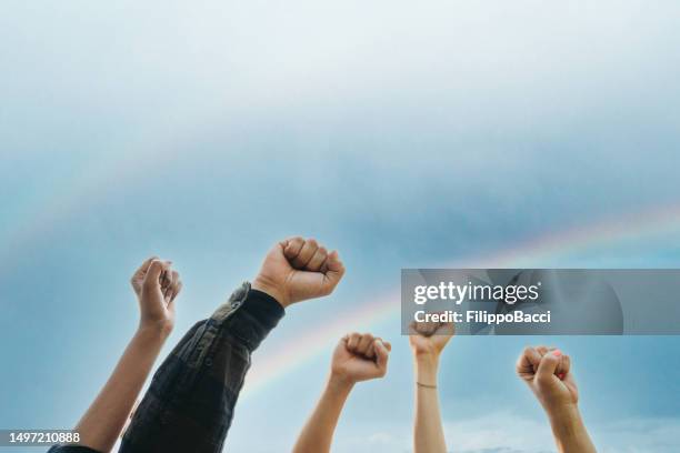 a group of activists are raising their fists - blm fist stock pictures, royalty-free photos & images