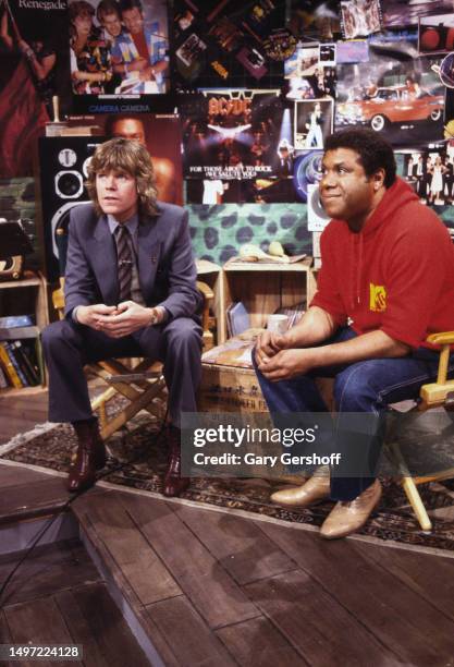 View of British Rock & Pop musician Peter Noone and American VJ JJ Jackson , both seated in director's chairs, during an MYV interview at Teletronic...