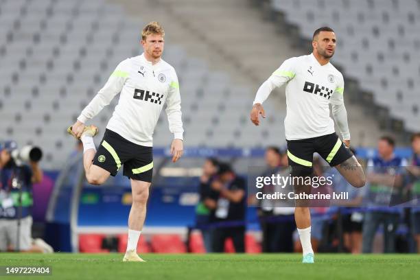 Kevin De Bruyne and Kyle Walker of Manchester City stretch during the Manchester City Training Session ahead of the UEFA Champions League 2022/23...