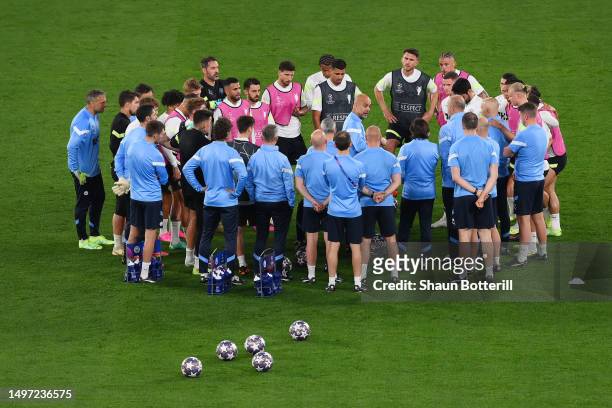 Pep Guardiola, Manager of Manchester City, talks to players of Manchester City during the Manchester City Training Session ahead of the UEFA...